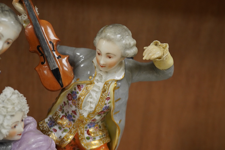 A large German porcelain group of ladies and a violinist, early 20th century, 23cm high